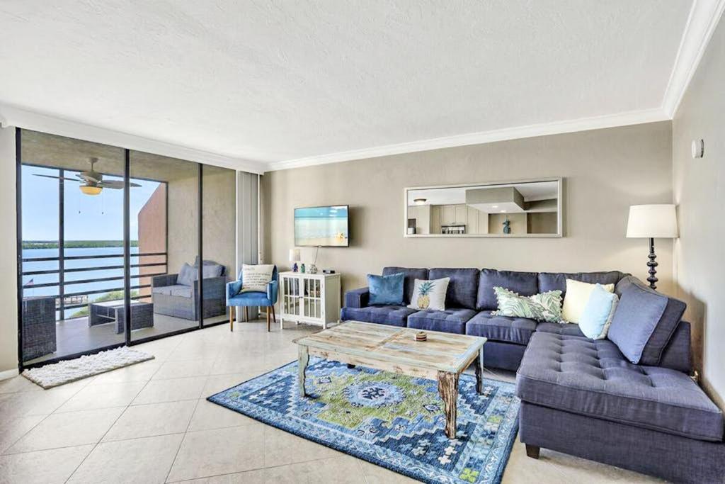 a living room with a couch and a table at Marco Magic in Marco Island