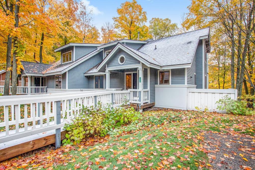 a blue house with a white fence at Mountainside 612 in Thompsonville