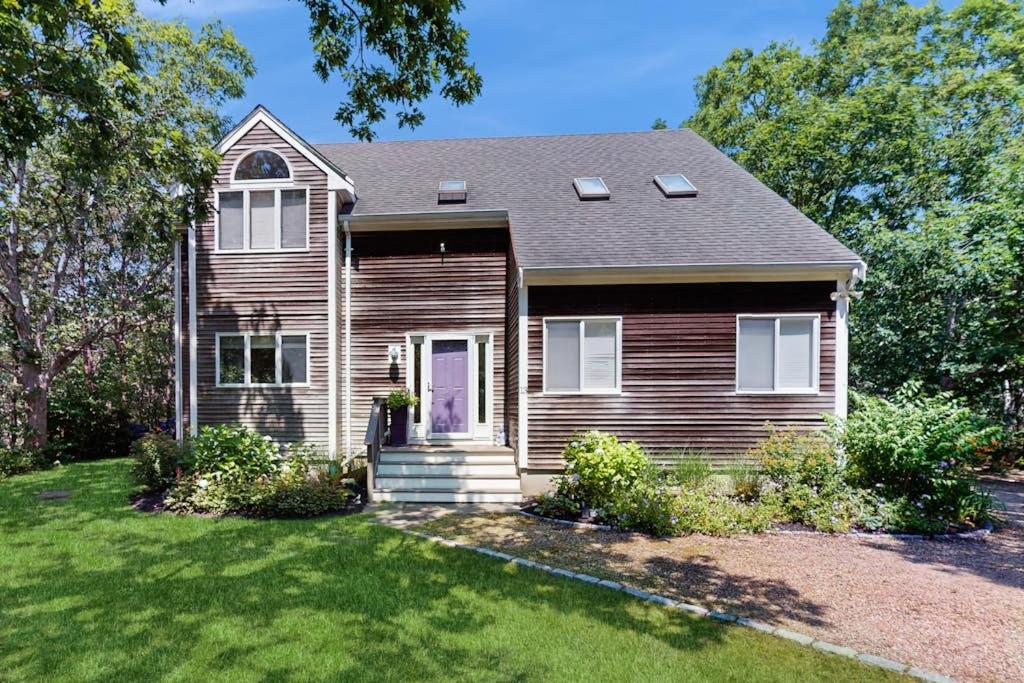 a brown house with a porch and a yard at The Big Easy in Oak Bluffs