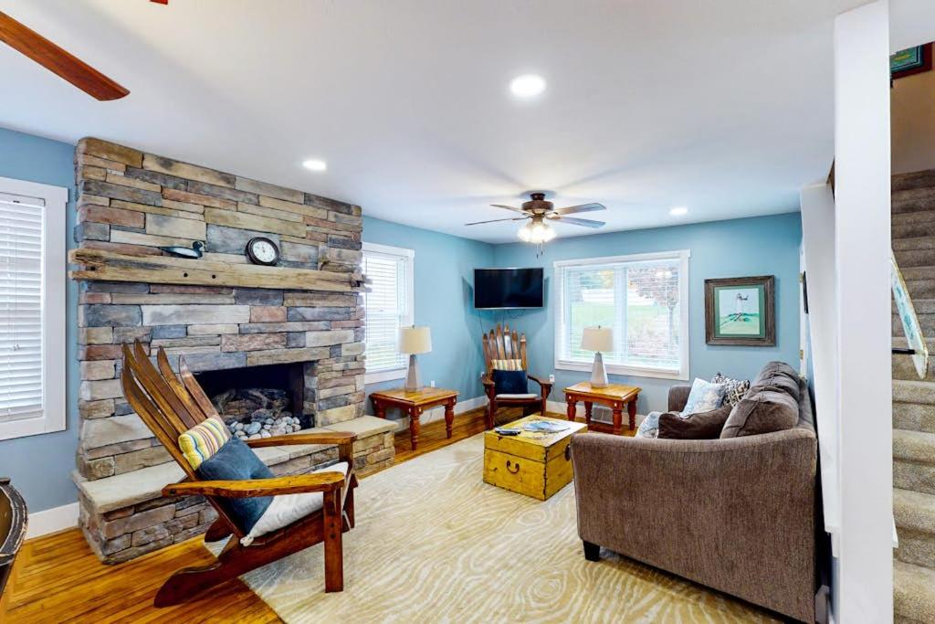 a living room with a large stone fireplace at Beach House in Empire