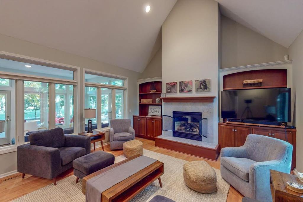 a living room with a fireplace and a tv at Deer Park 9 in Glen Arbor