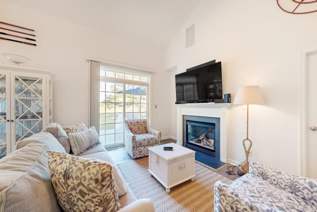 a living room with a couch and a fireplace at Bear Trap Dunes---26 Willow Oak Ave in Ocean View