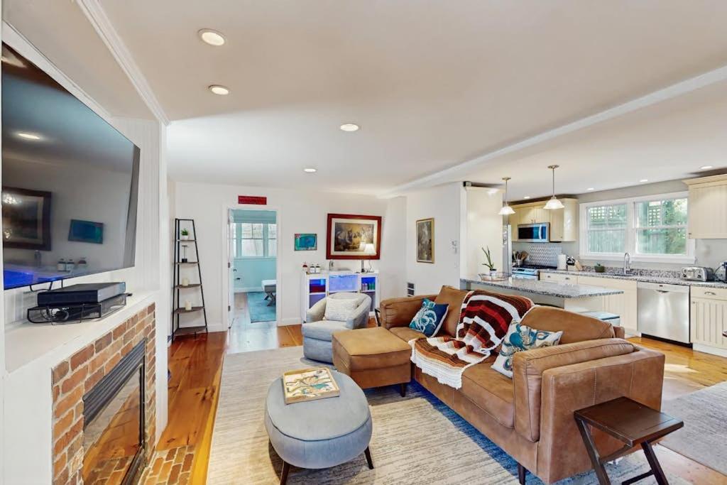a living room with a couch and a fireplace at Wraparound Hideaway in Provincetown
