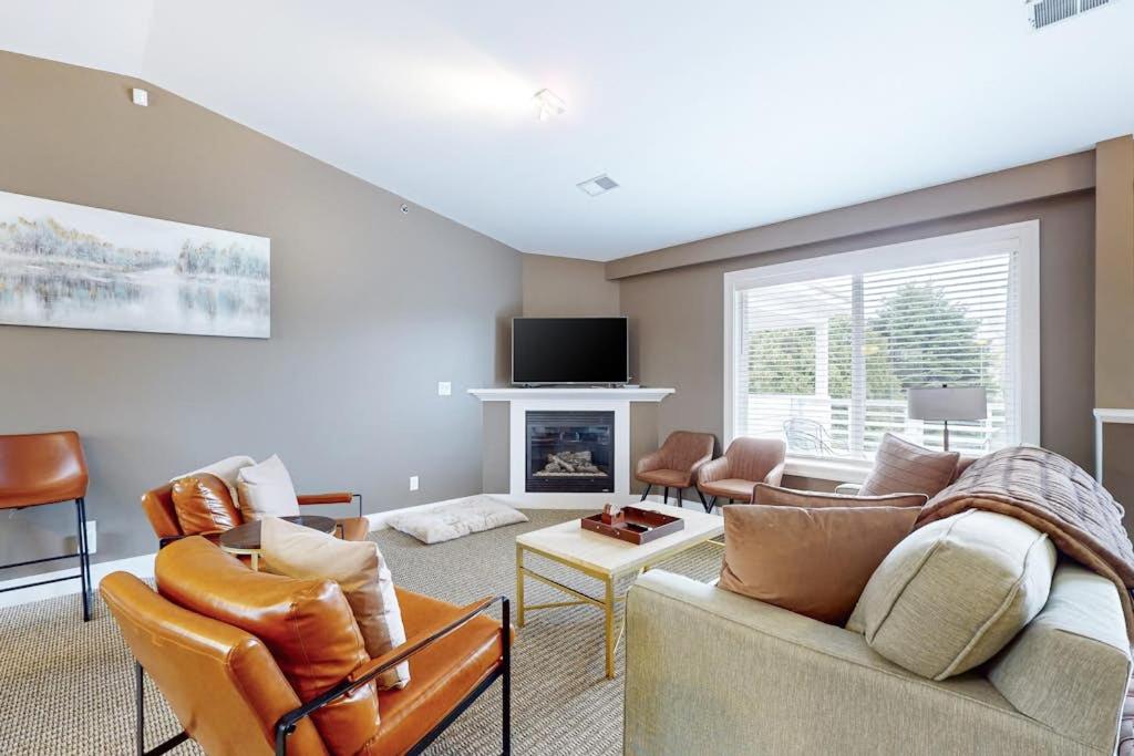 a living room with a couch and a fireplace at Northern Light Condominiums: Jack's Perch in Douglas