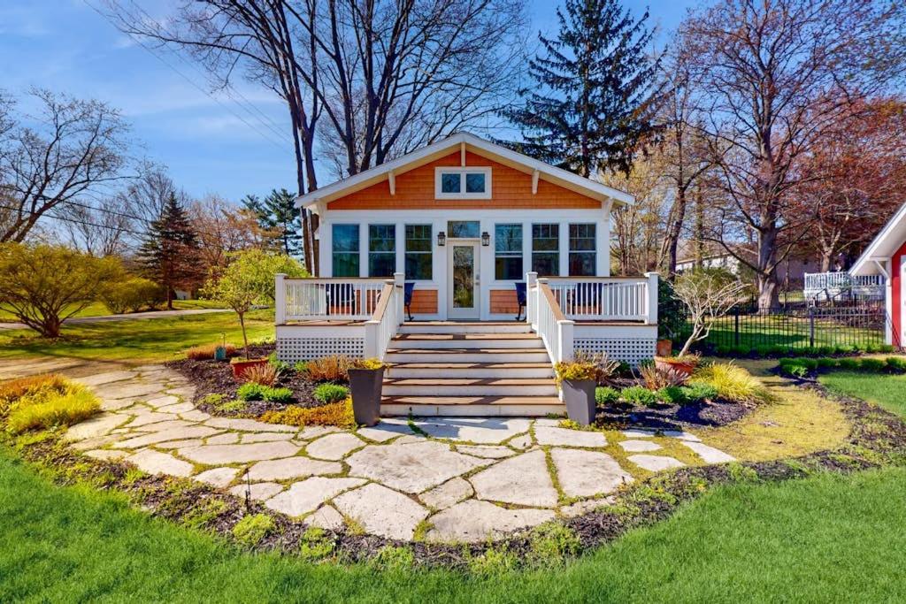 a small house with a porch and a walkway at Rise n Shine in Saugatuck