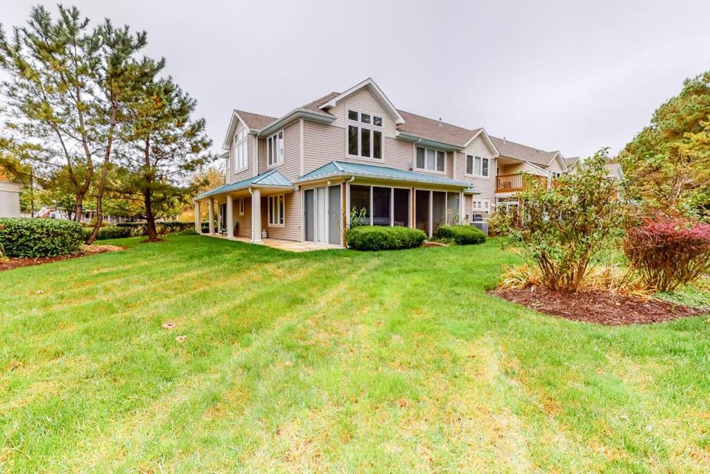 a large house with a large yard with grass at Sea Colony - 56010 Pine Shore in Bethany Beach