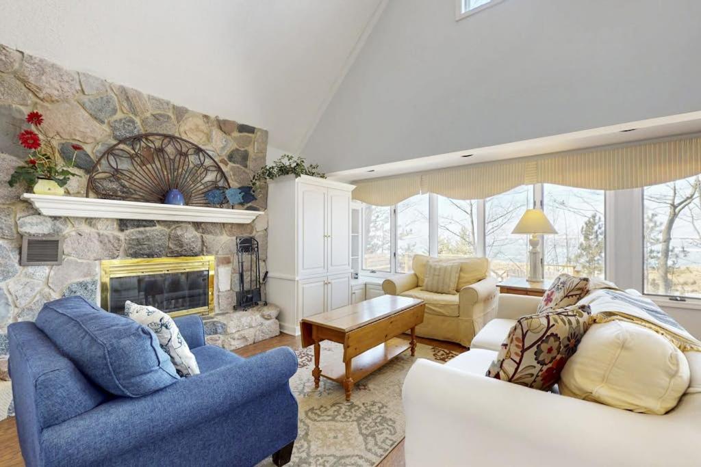 a living room with two chairs and a fireplace at Heron Creek in Laketown Township