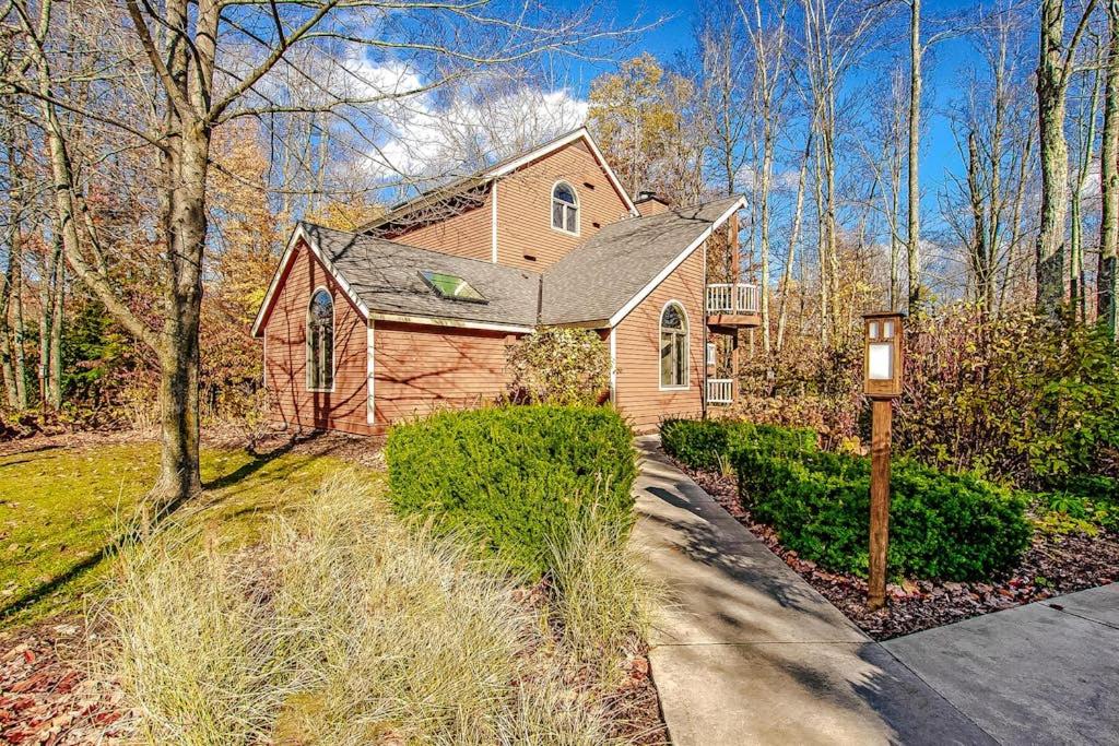 a home with a driveway leading to a house at Crystal Mountain Condo - Wintergreen 535 in Thompsonville