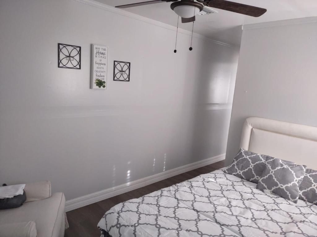 a bedroom with a bed and a ceiling fan at my place to be in Port Charlotte