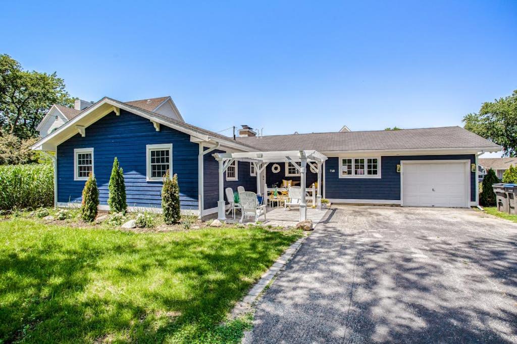 a blue house with a driveway in front of it at Surf's Up in New Buffalo