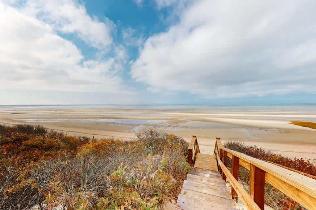 a wooden boardwalk leading to a sandy beach at Life's Better at the Beach in Eastham