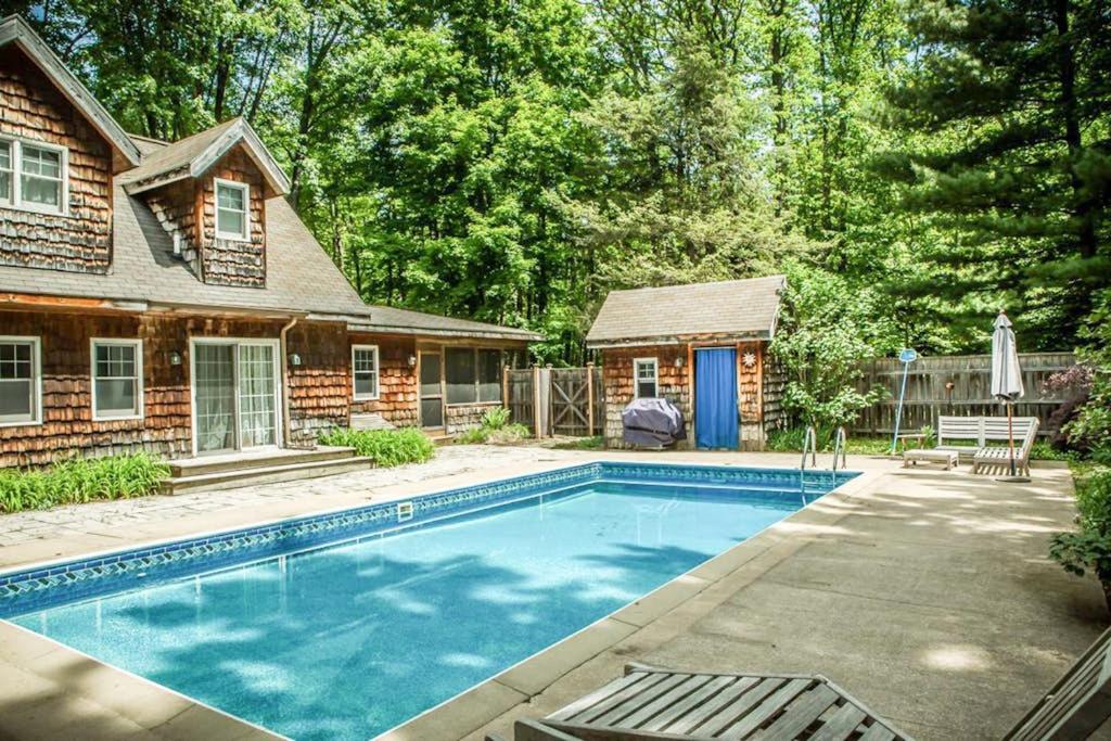 a swimming pool in front of a house at La Colita in Harbert