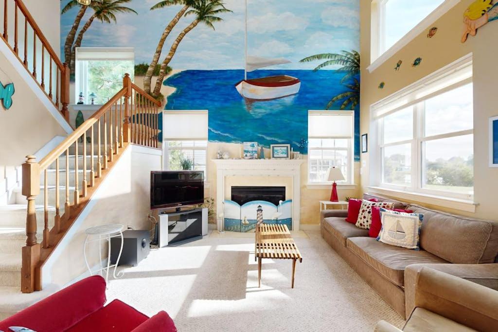 a living room with a mural of a boat on the wall at Wedgefield --- 23 Wedgefield in Ocean View