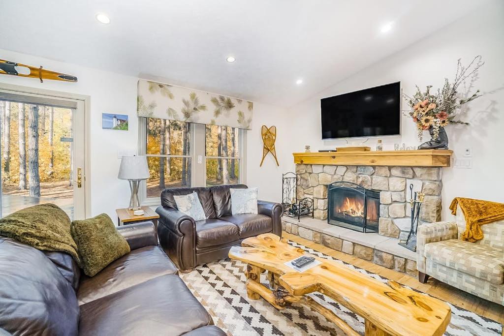 a living room with a couch and a fireplace at Red Pine Retreat in Thompsonville
