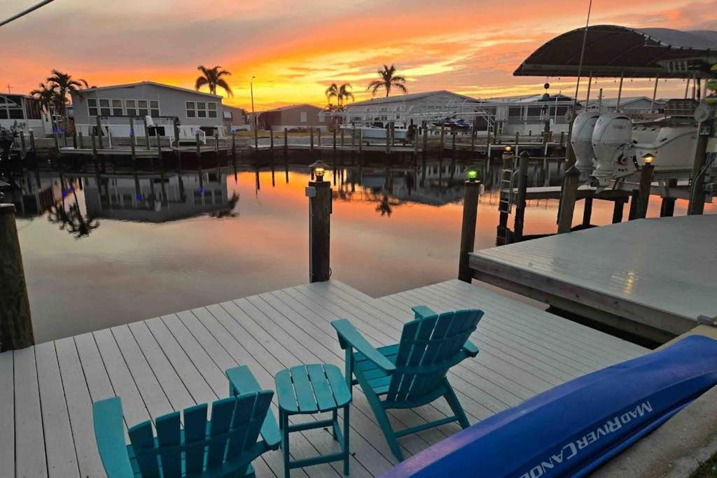 two chairs and a table on a dock with a sunset at Lavender Life in Saint James City