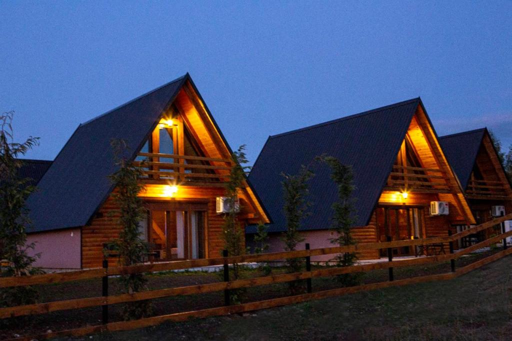 a wooden house with two large black roofs at Bugen Villa II in Žabljak
