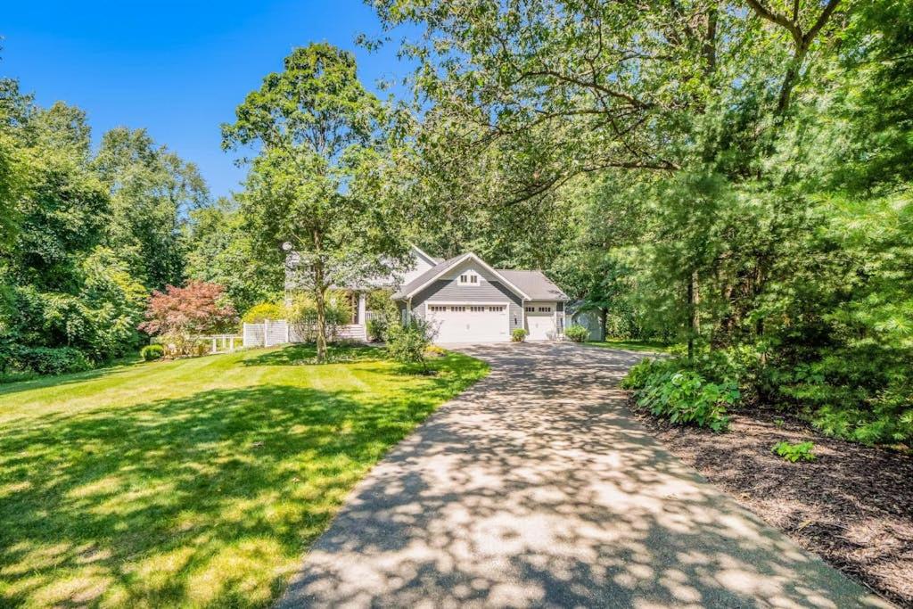 a driveway leading to a house with a garage at Borrowed Thyme in Saugatuck