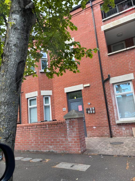 a brick building with a door on the side of it at Queens apartments Belfast in Belfast