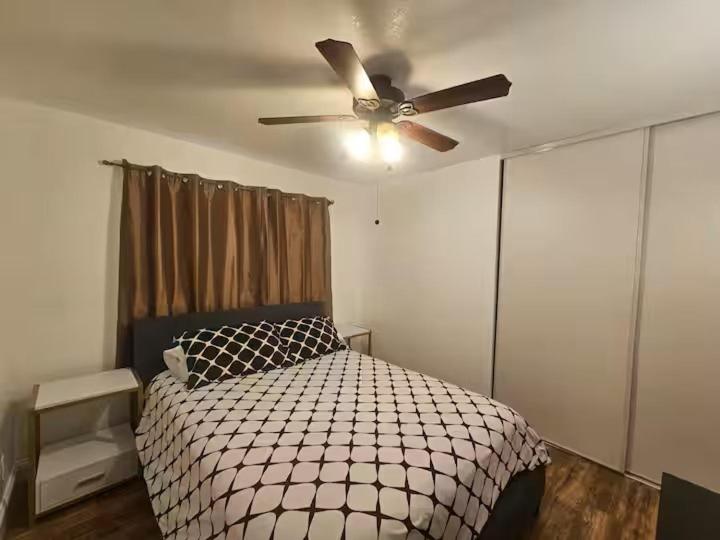 a bedroom with a bed with a ceiling fan at Urban Retreat -Suite A in San Jose