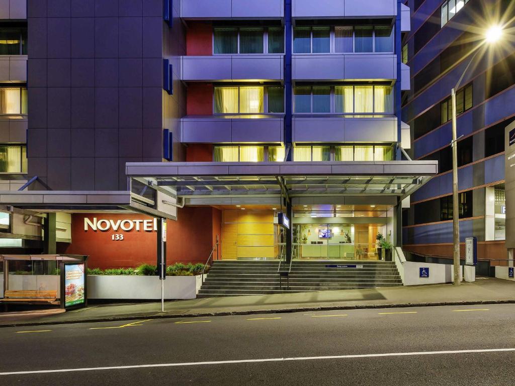 a building on a city street at night at Novotel Wellington in Wellington