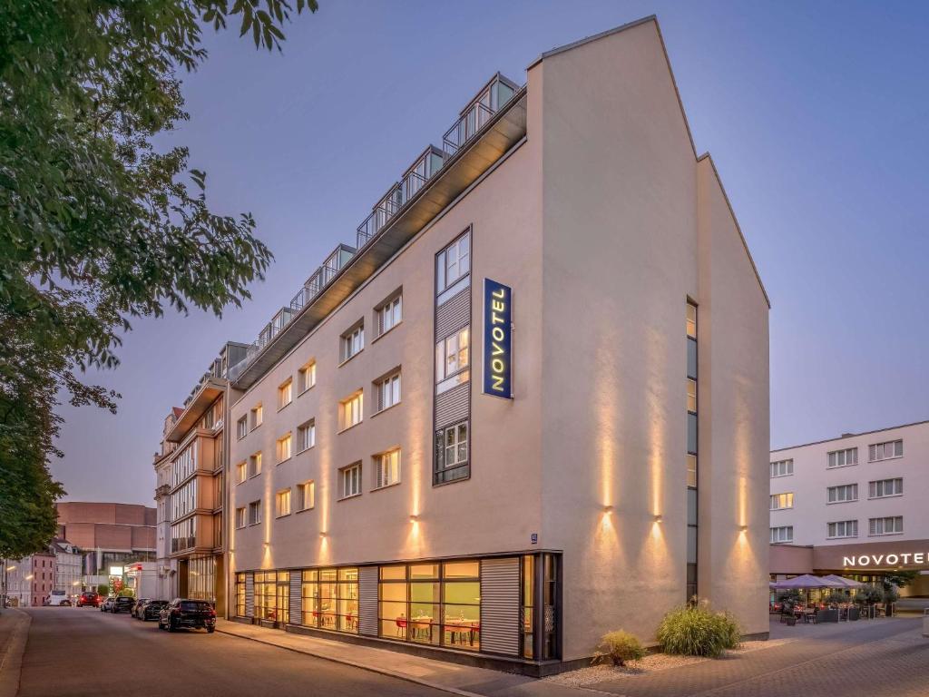 a building with a sign on the side of it at Novotel München City in Munich