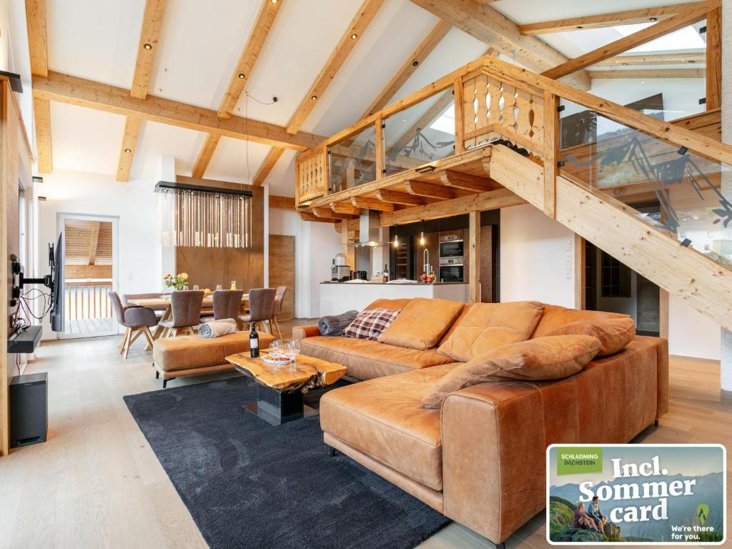 a living room with a couch and a staircase at Apart33 Top 1-33 Penthouse in Haus im Ennstal