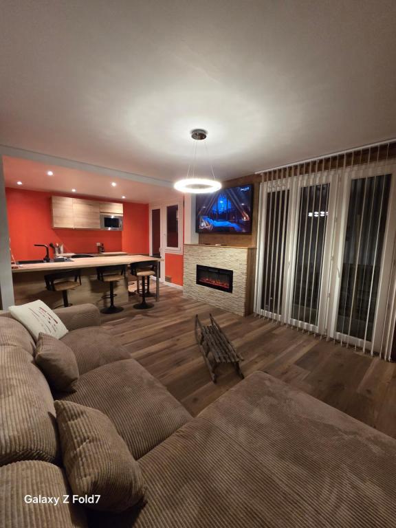 a living room with a couch and a pool table at JOLYKa résidence avec caméra et digicode possibilité location voiture Mercedes, garage ,climatisation ,cheminée, Netflix, petit déjeuner ,repas du soir fondue, raclette, barbecue sur demande in Albertville