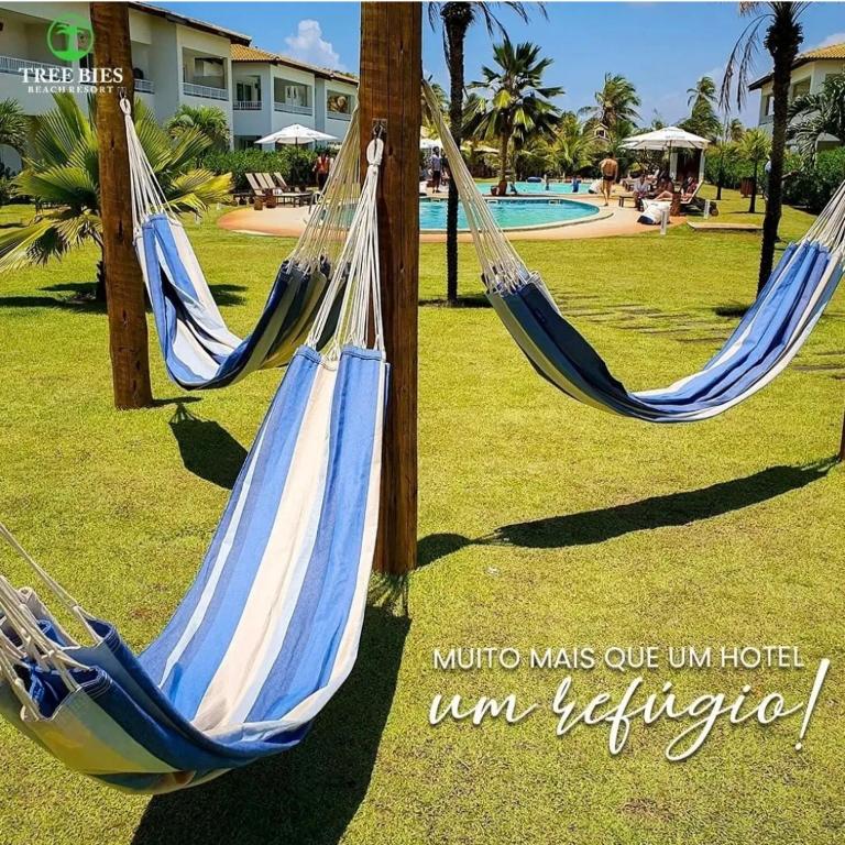two hammocks in a park with a pool at Tree Bies in Entre Rios