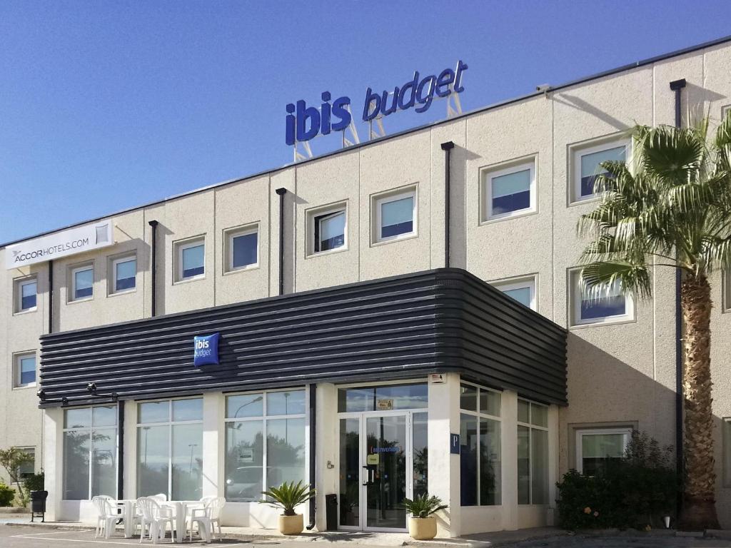 a building with a sign on top of it at Ibis Budget Alicante in Alicante