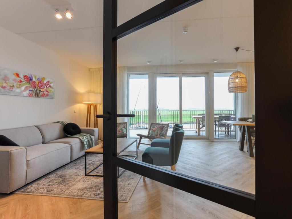 a living room with a couch and a table at Zilte Haven in Kamperland