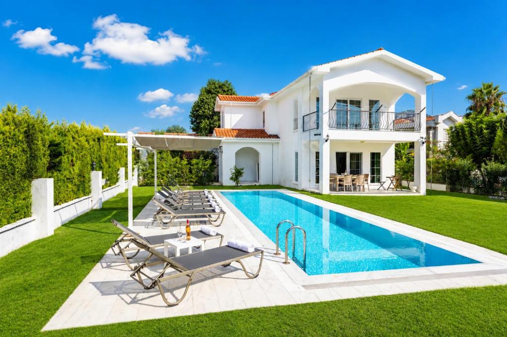 a villa with a swimming pool in front of a house at Villa Crystal in Dalyan