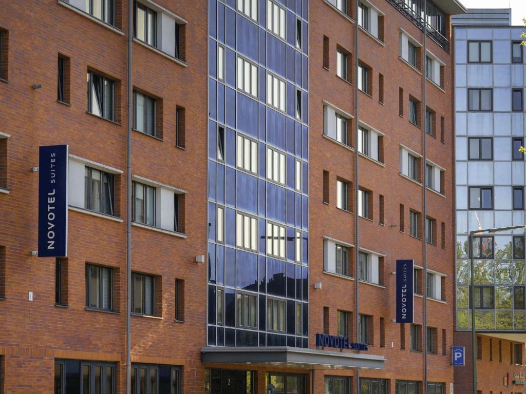 a tall brick building with blue windows at Novotel Suites Berlin City Potsdamer Platz in Berlin