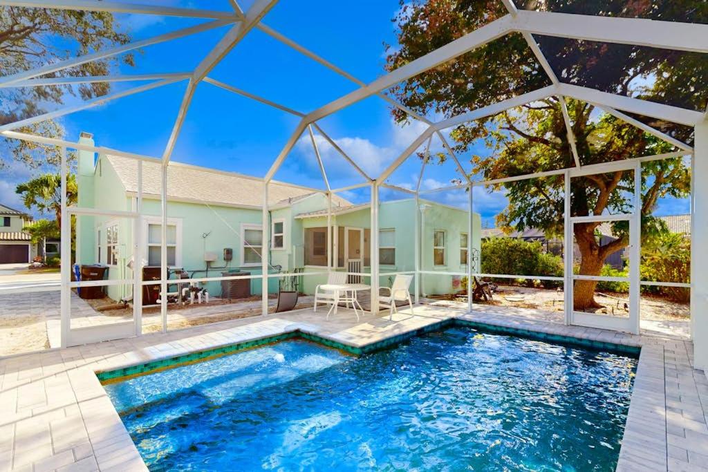 a swimming pool in front of a house at Vintage Venice Duplex - A in Venice