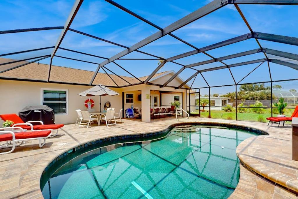 an indoor swimming pool with a retractable roof at No Regrets in Englewood