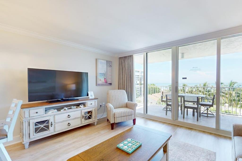 a living room with a television and a dining room with a table at Marco Beach Ocean Resort 801 in Marco Island