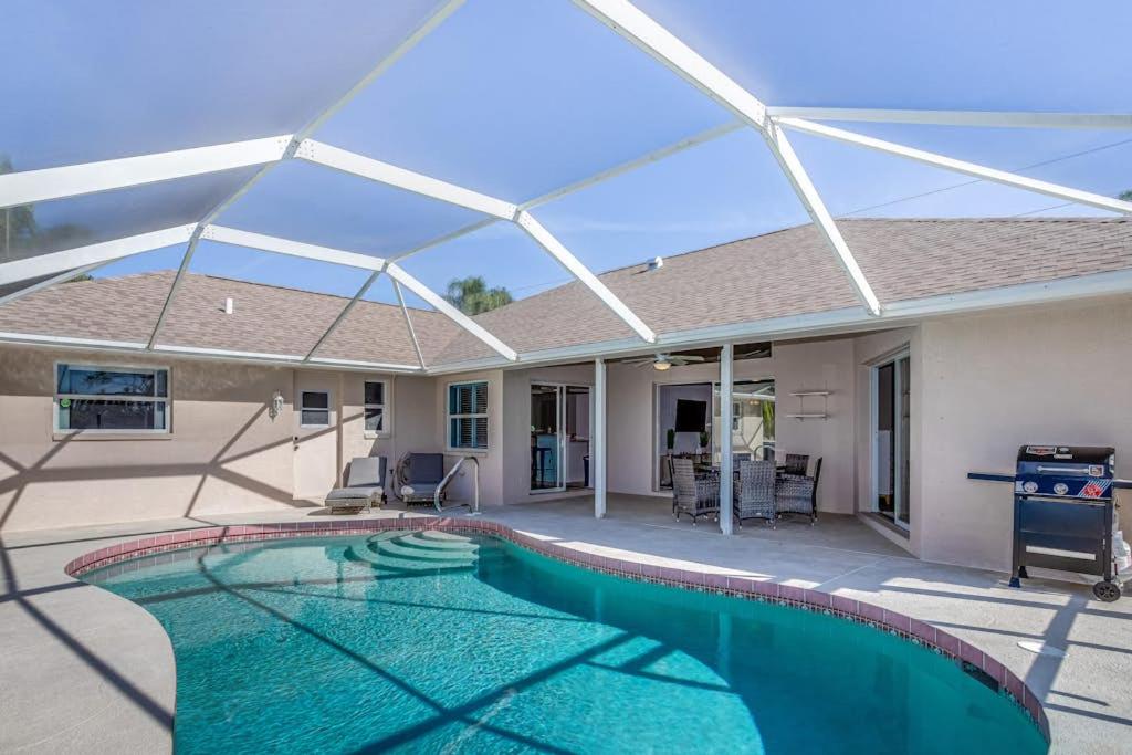 a swimming pool in front of a house at Hook, Line, and Sunsets in Port Charlotte