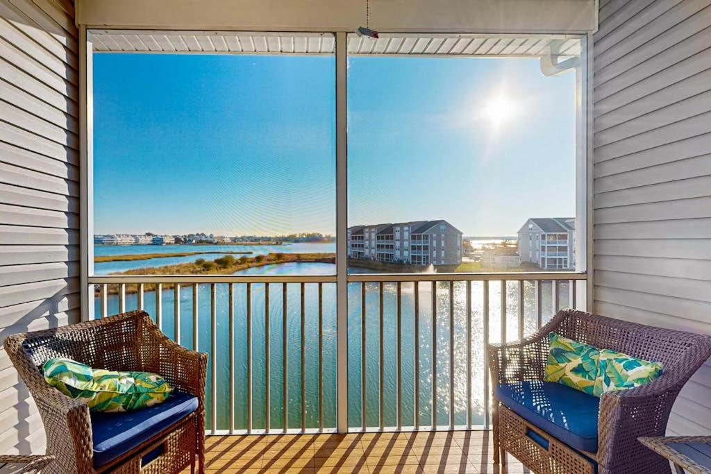 a balcony with two chairs and a view of the water at Bethany Bay --- 37182 Harbor Dr #2606 in Ocean View