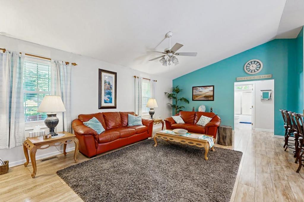 a living room with red leather furniture and blue walls at Ocean Way Estates - 32563 W Riga Dr in Ocean View