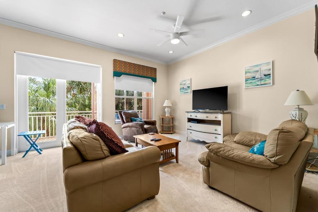 a living room with two couches and a television at White Coral in Placida