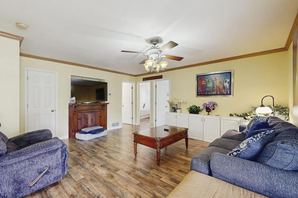 a living room with two couches and a table at Moose's House --- 70 Radcliffe Rd. in The Plantations