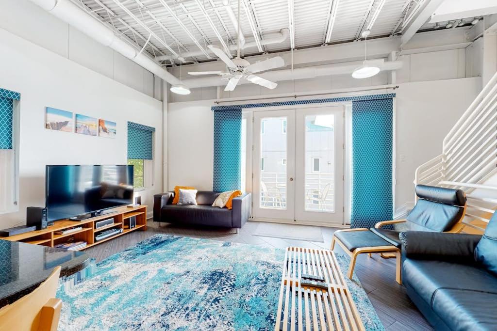 a living room with a couch and a tv at Rehoboth Beach -- Forj Lofts #8 in Rehoboth Beach