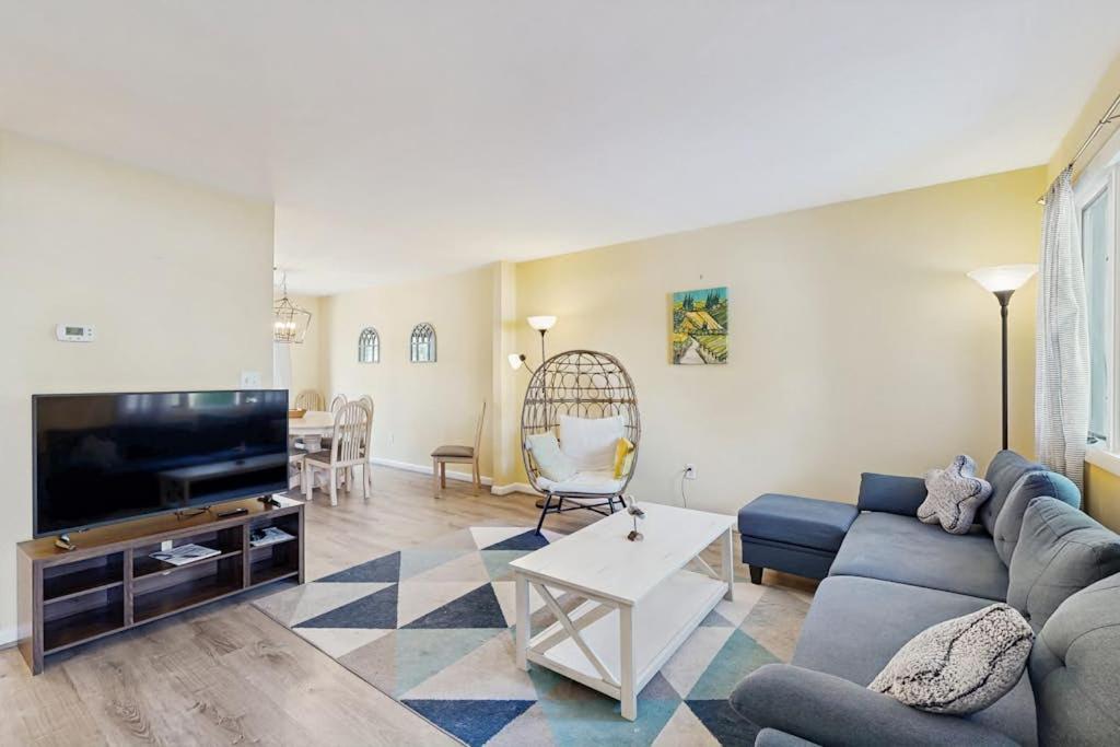 a living room with a couch and a tv at Bethany Pines - 431 Bethany Pines in Bethany Beach