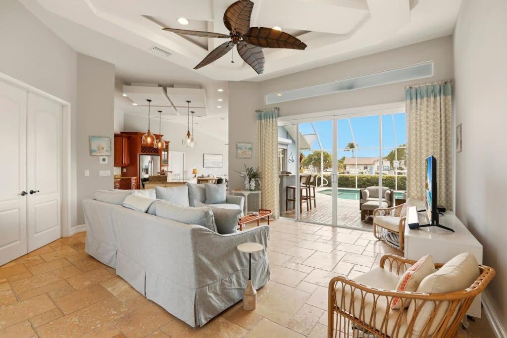 a living room with a couch and a television in it at Marco Paradise in Marco Island