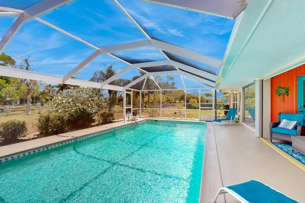 an indoor pool in a house with an open ceiling at Seaside Serenity in Punta Gorda
