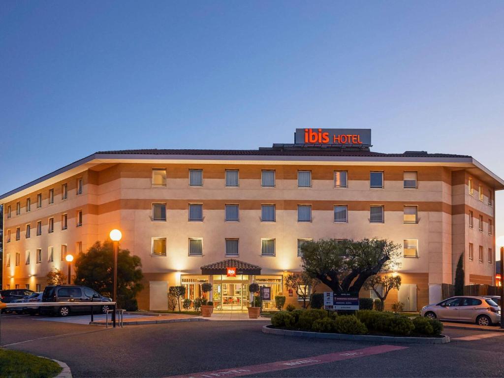 a hotel building with a sign on top of it at ibis La Ciotat in La Ciotat