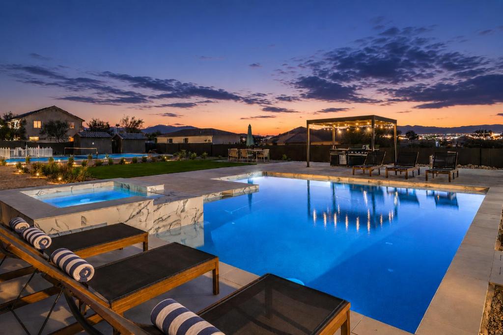 a large swimming pool with a patio and a house at CIELO - Modern Vegas Pool Oasis, Spa, Pickleball in Las Vegas