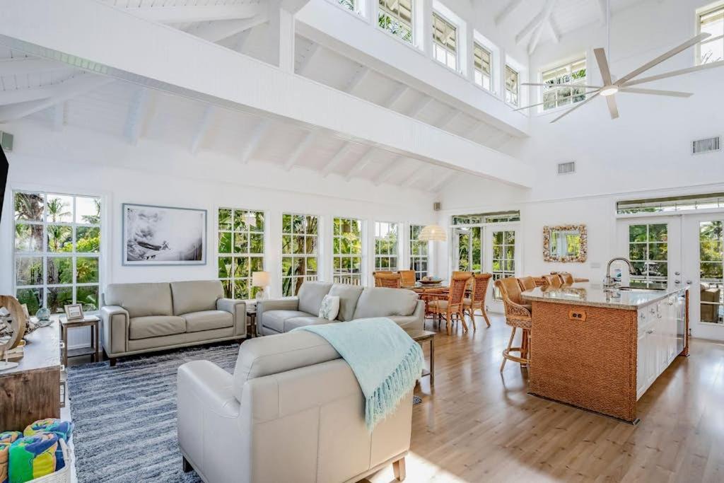 a large living room with white furniture and windows at Bocilla Breeze in Bokeelia