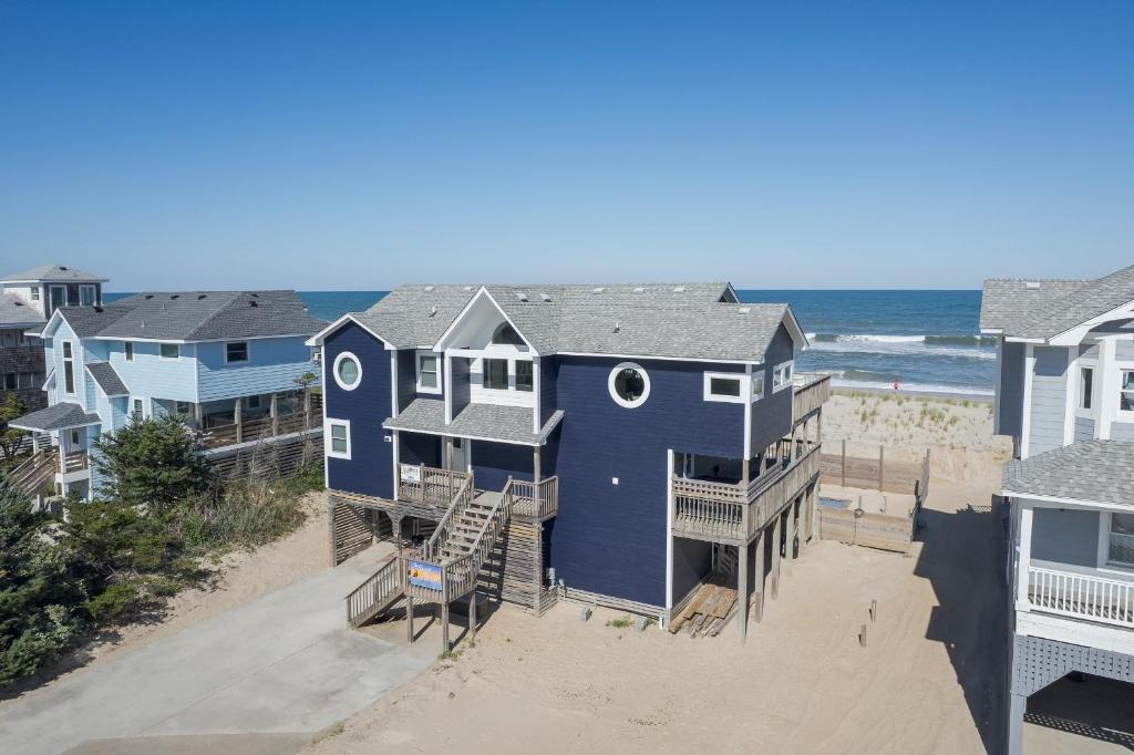 an aerial view of a blue house on the beach at 7674 - The Sweet Escape in Avon