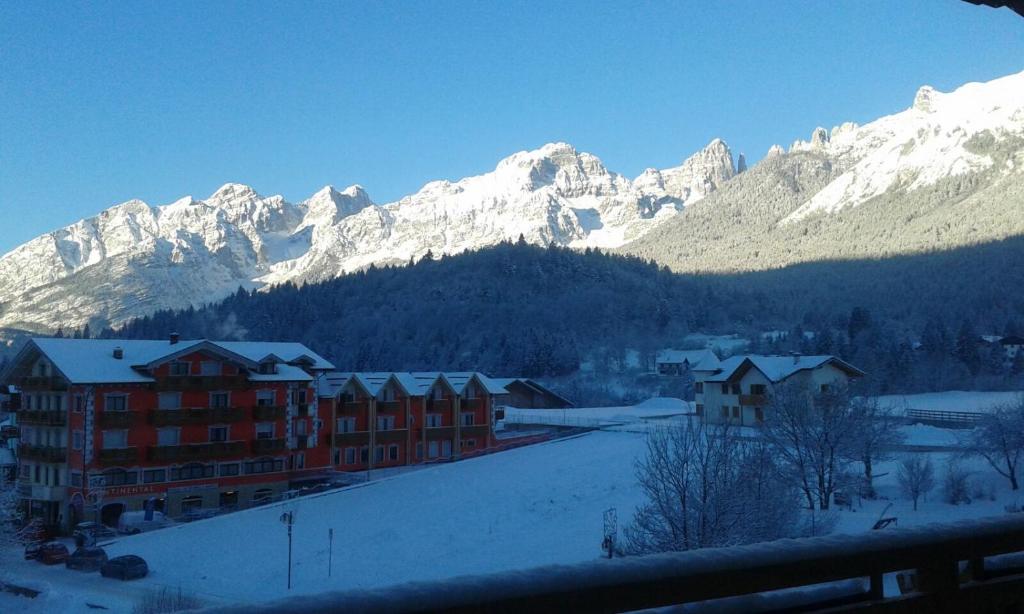 a city with snow covered mountains in the background at Appartamento Mariastella in Andalo