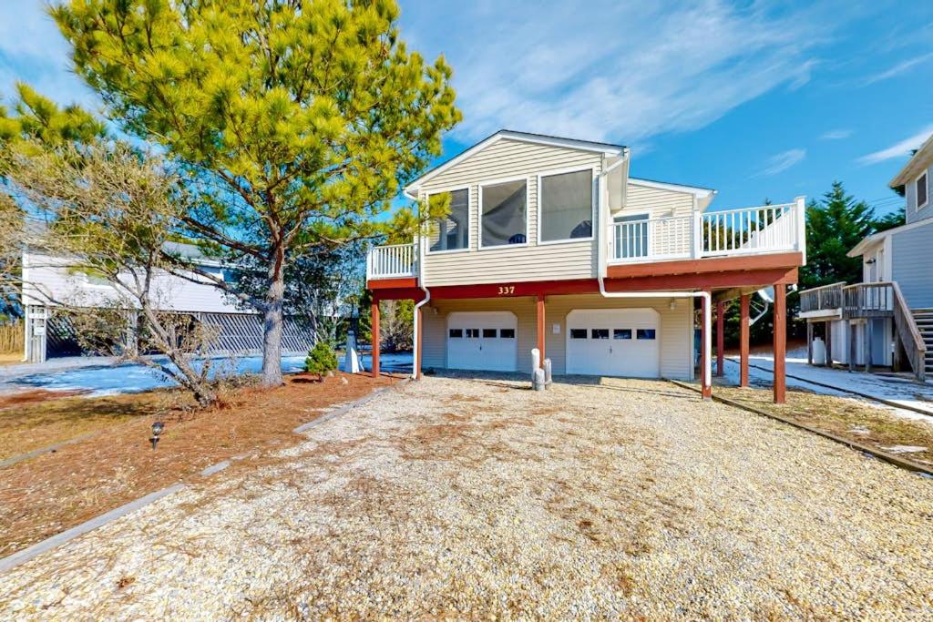 a house with a dog standing in the driveway at The Canal -- 337 Sandpiper in Bethany Beach